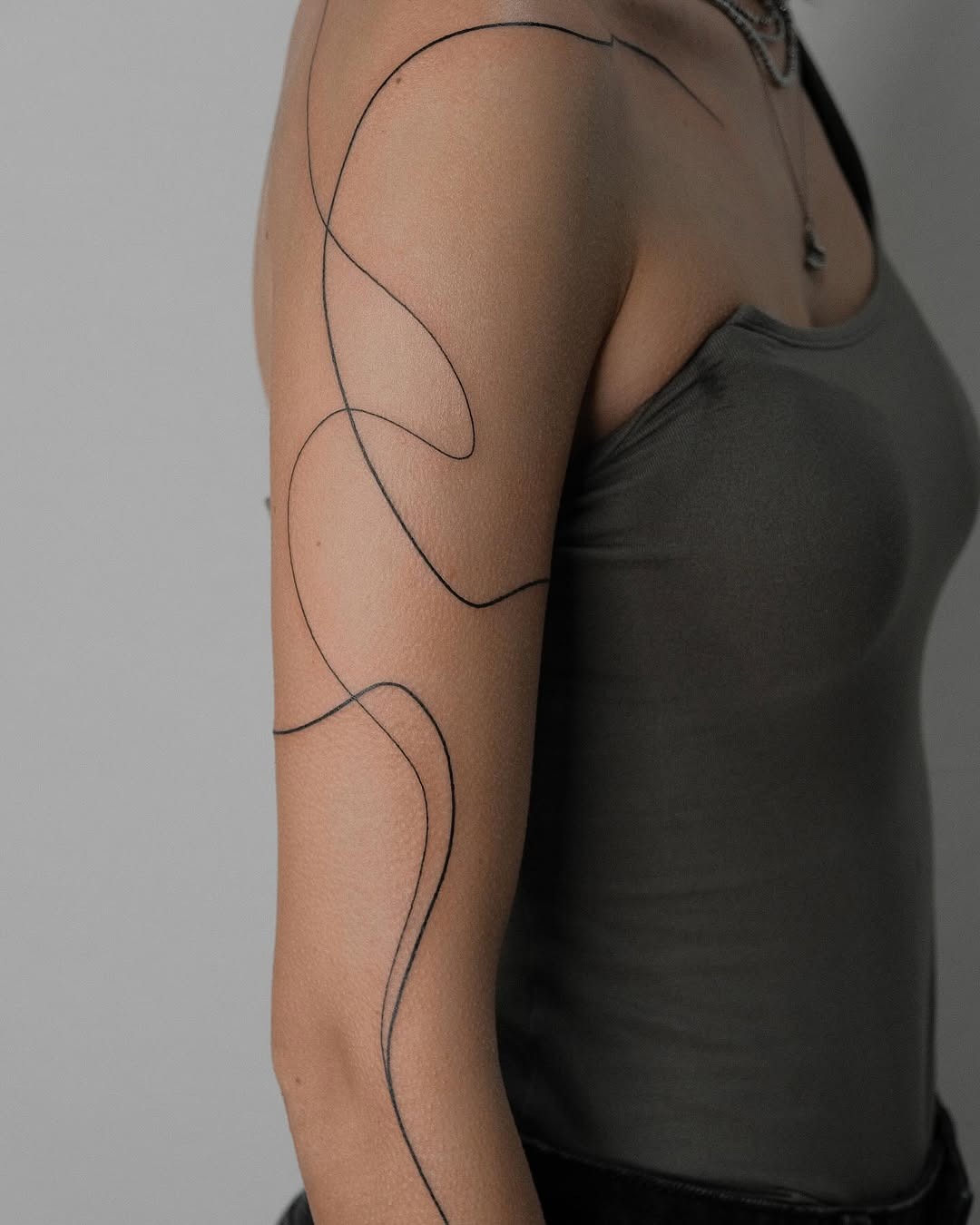 Elegant black line tattoo for stylish women Tattoo Design