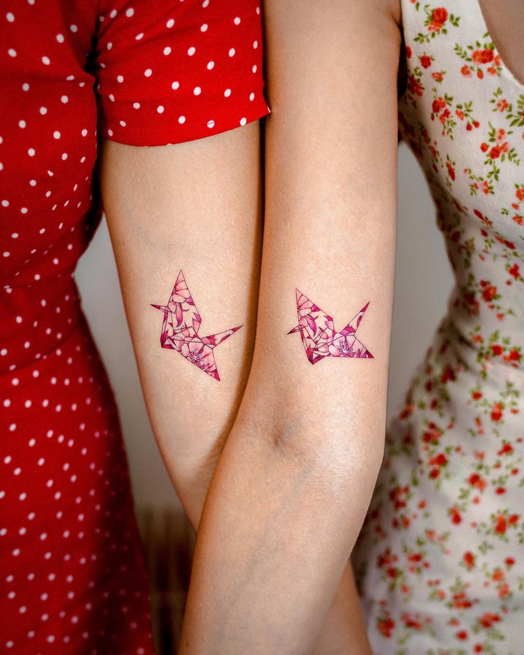 Elegant pink crane tattoos on feminine arms Tattoo Design