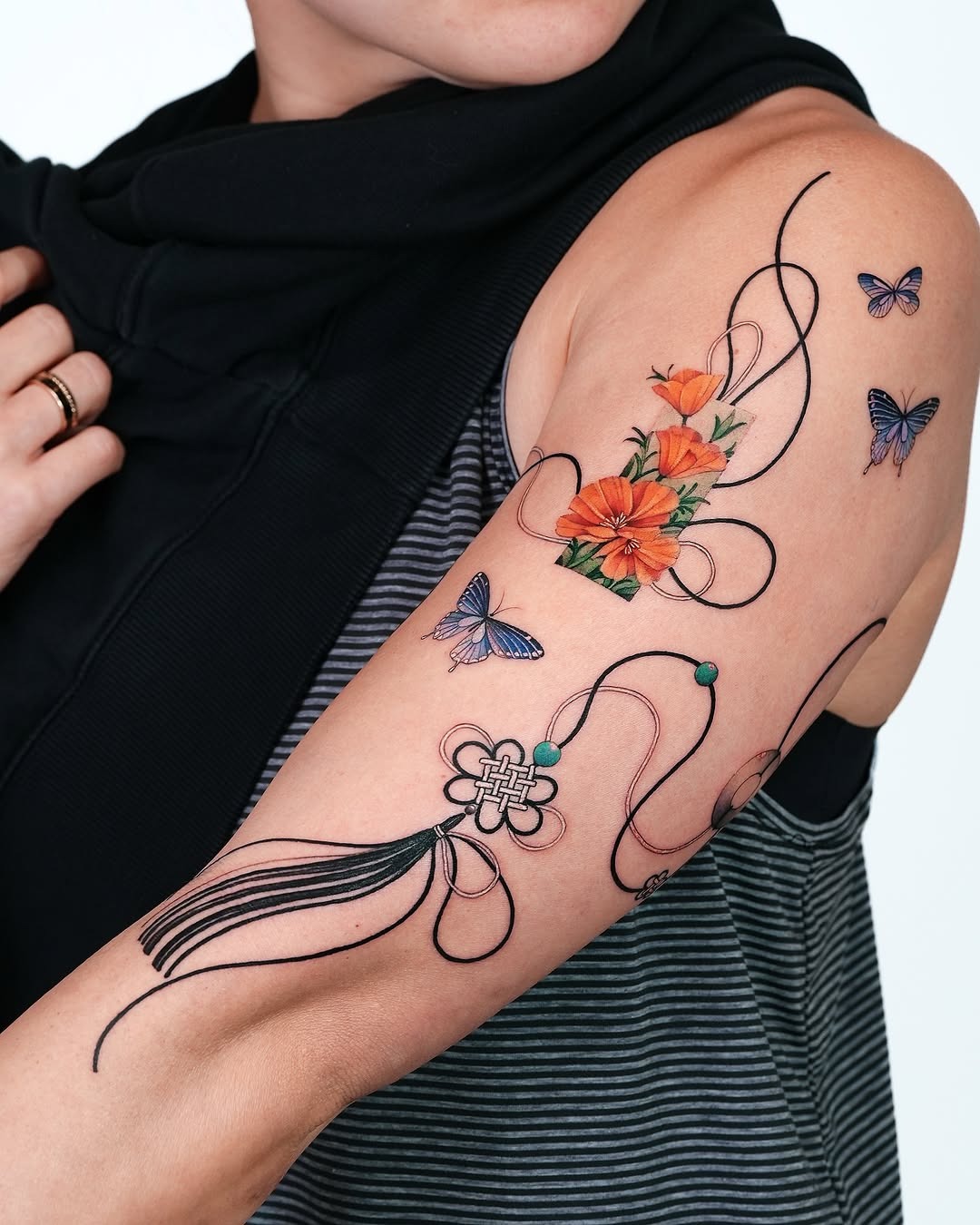 Vibrant floral and butterfly arm tattoo design Tattoo Design
