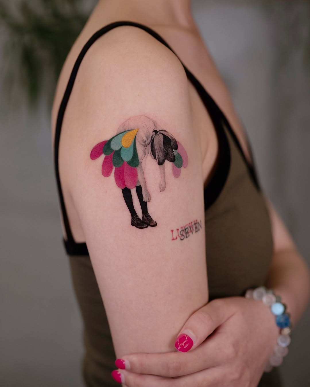 Whimsical arm tattoo with colorful wings Tattoo Design