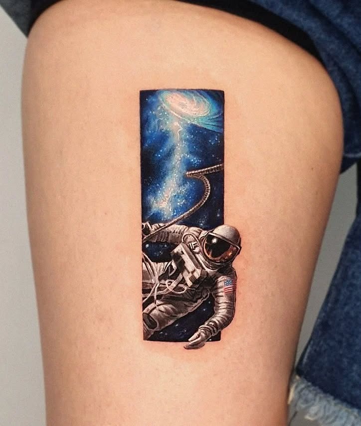 A stunning astronaut tattoo in deep space Tattoo Design