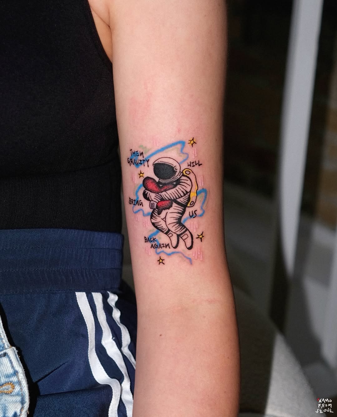 Adorable astronaut tattoo with a cosmic theme Tattoo Design