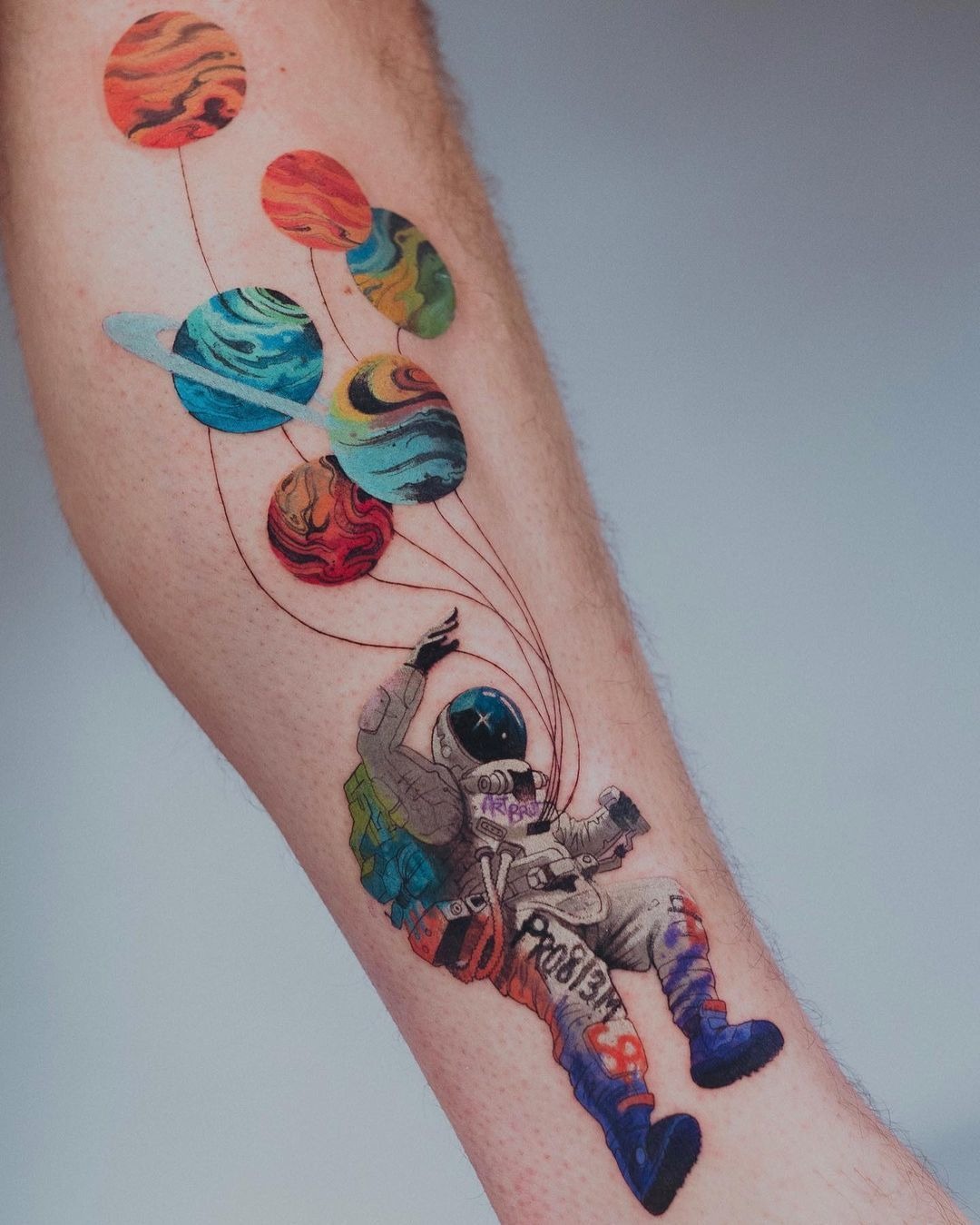 Playful astronaut floating with planet balloons Tattoo Design