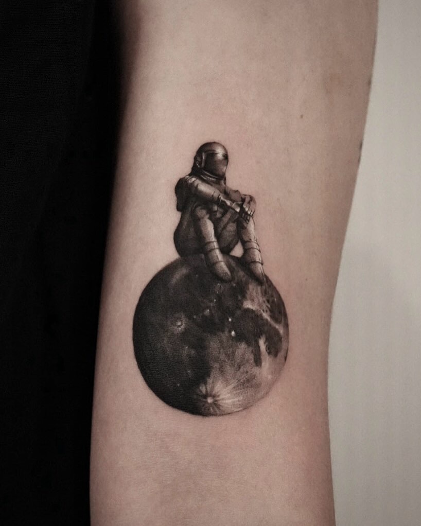 Stunning astronaut tattoo on a moon. Tattoo Design