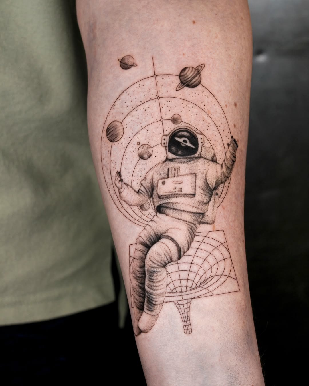 Unique Spacesuit Tattoo with Cosmic Elements Tattoo Design