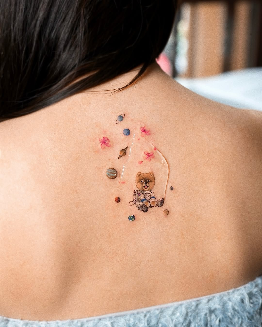 Whimsical astronaut bear amidst cosmic elements Tattoo Design