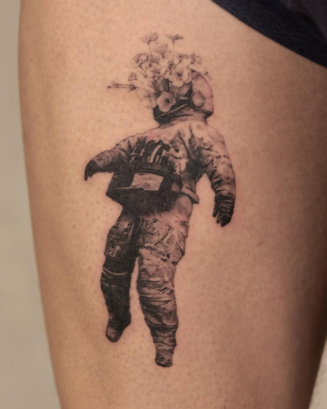 Whimsical astronaut with a floral twist Tattoo Design