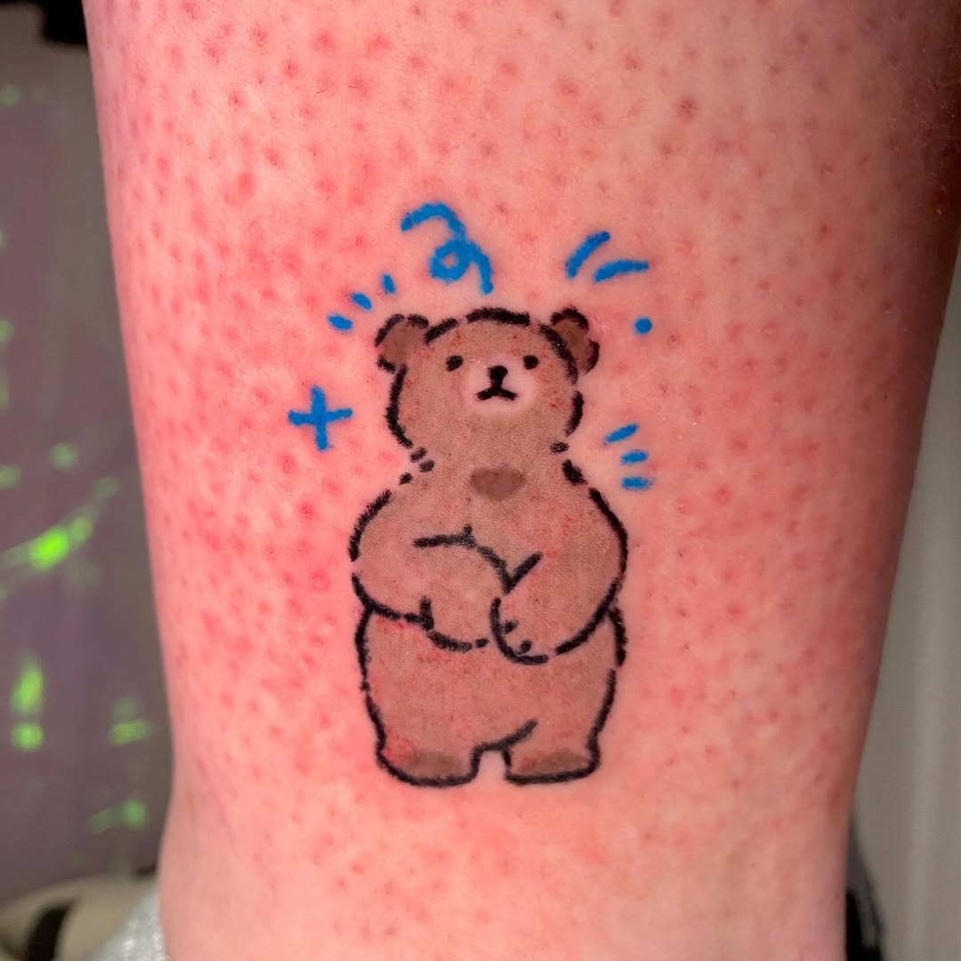 This bear tattoo features a cute, simplistic design that exudes charm.