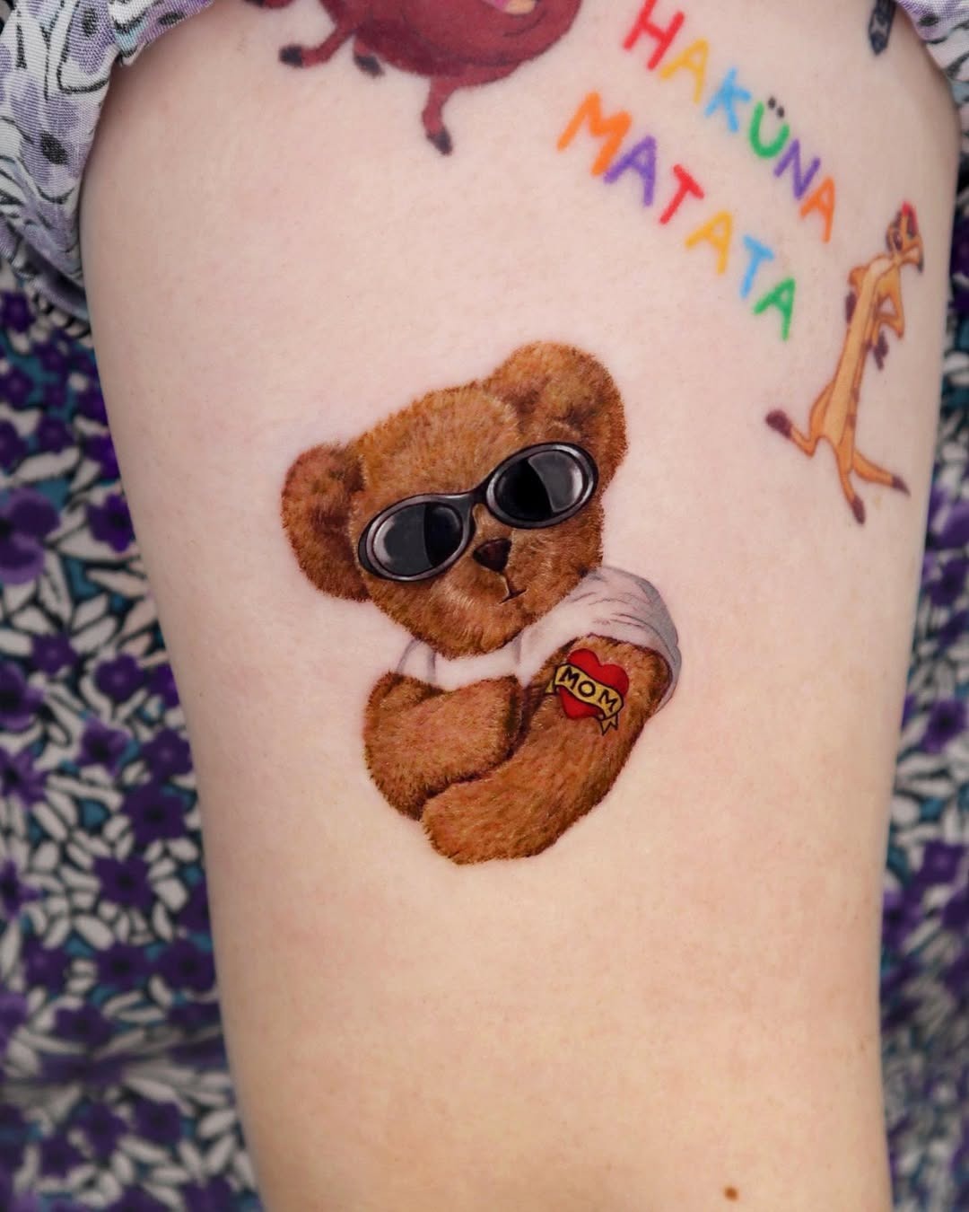 This tattoo features an adorable bear wearing sunglasses, embodying a cool and playful spirit.