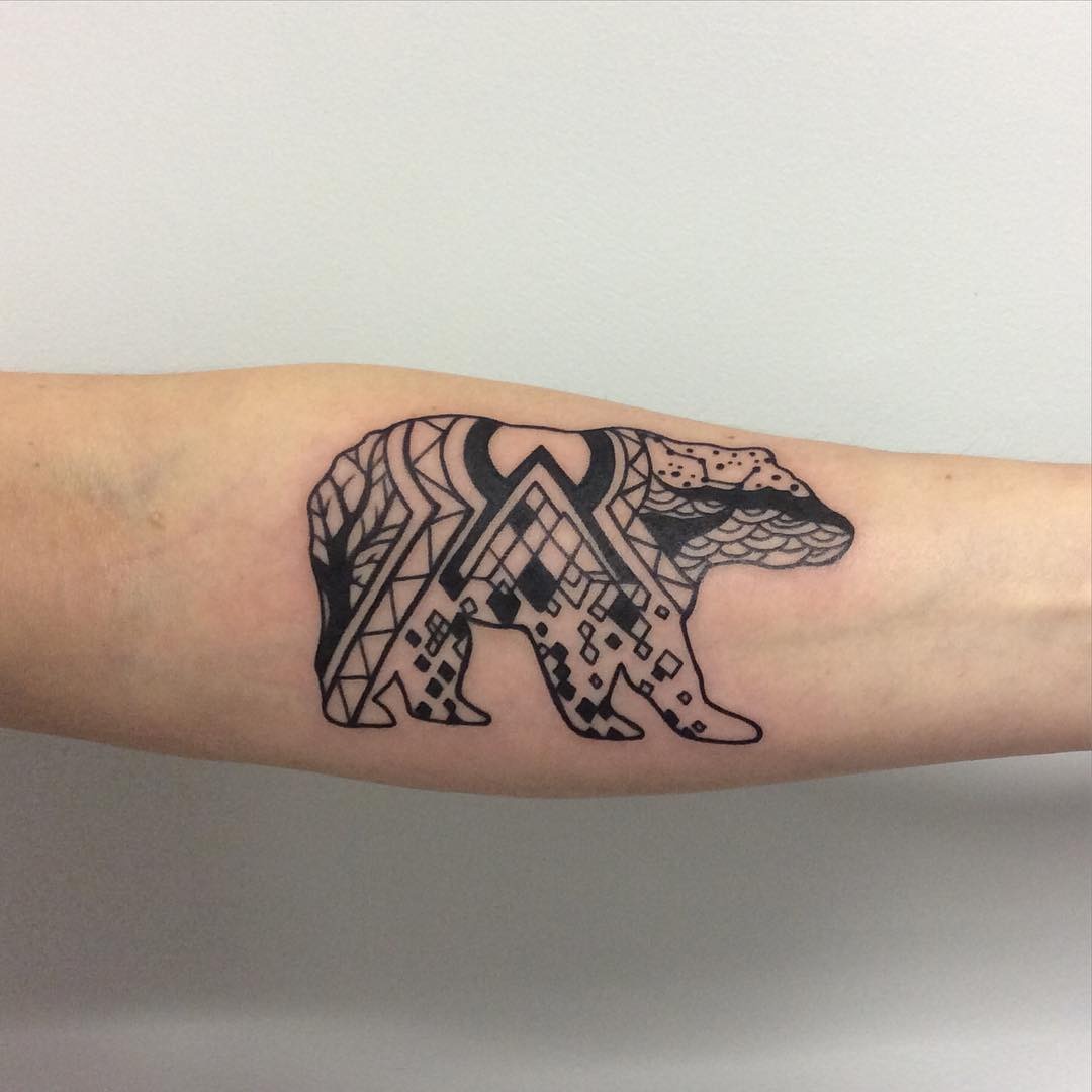 This tattoo showcases a stunning geometric representation of a bear.