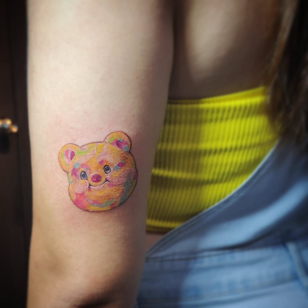 This cute bear tattoo features a uniquely colorful and artistic design.