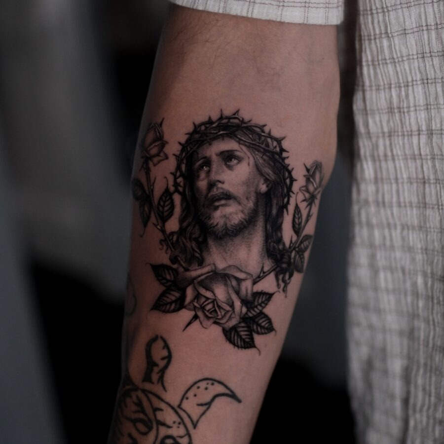 Intricate Jesus tattoo with rose accents Tattoo Design