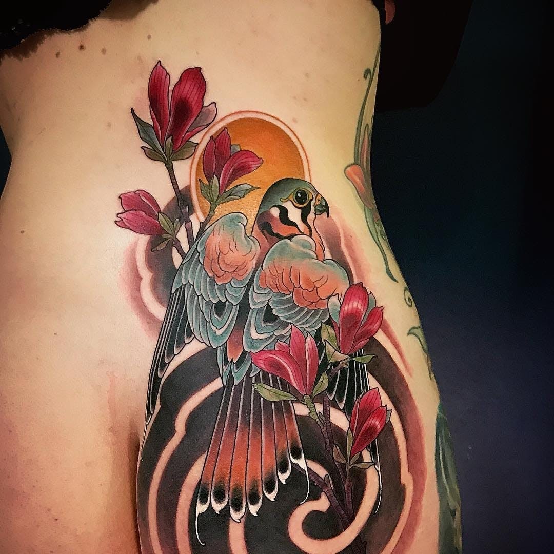 Unique TattoosIdea: Brightly Colored Bird Tattoo with Black Swirls Tattoo Design