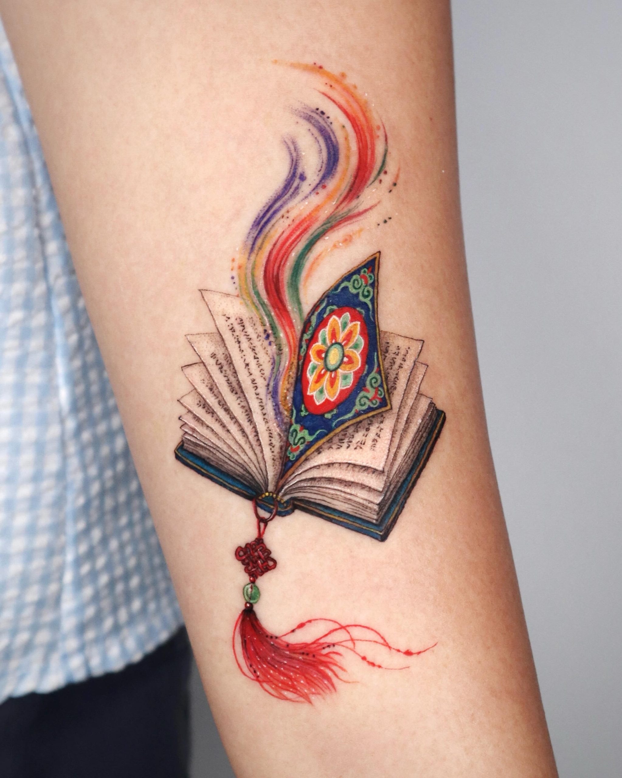 Open Book With Colorful Magic Pages Tattoo Tattoo Design