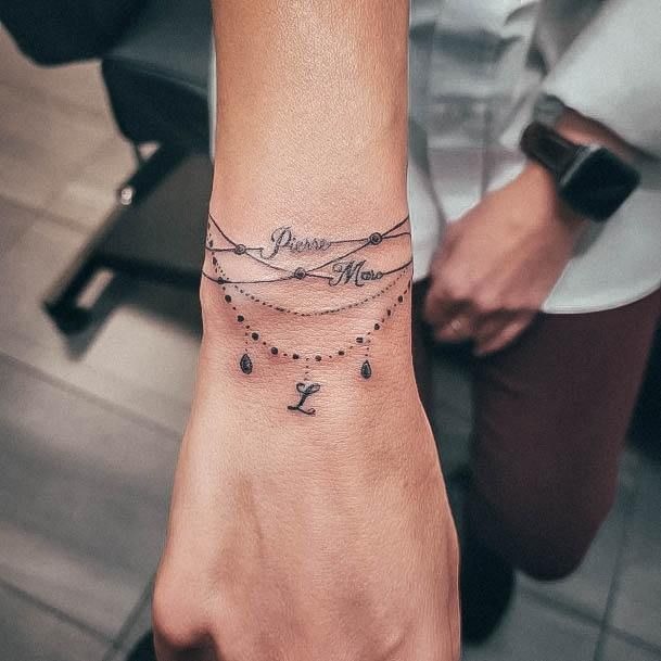 Delicate Script and Beaded Layers Tattoo Design