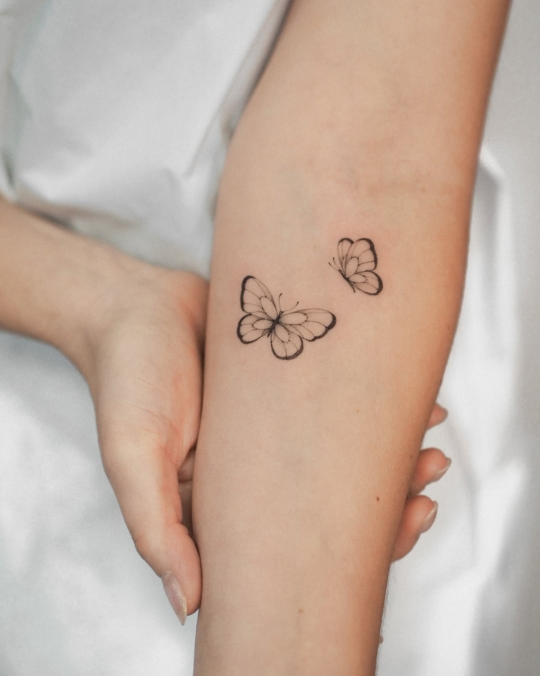 The design centers on elegant and minimalistic butterfly imagery that reads clearly at a glance.