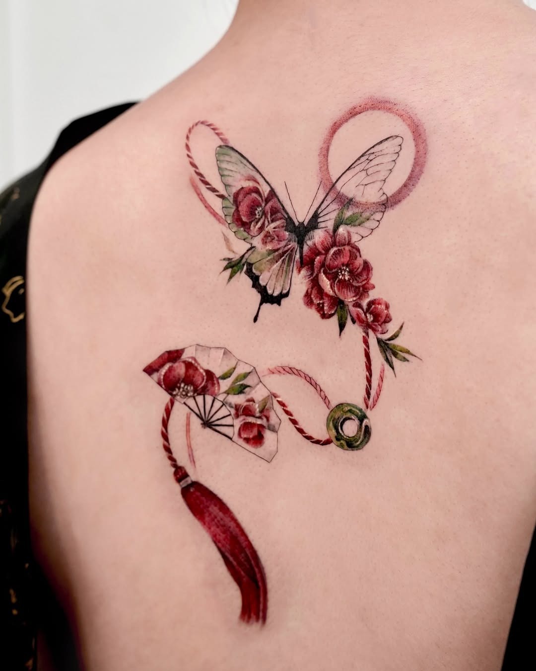 This tattoo features a stunning butterfly surrounded by flowers, creating a harmonious blend of nature's beauty.