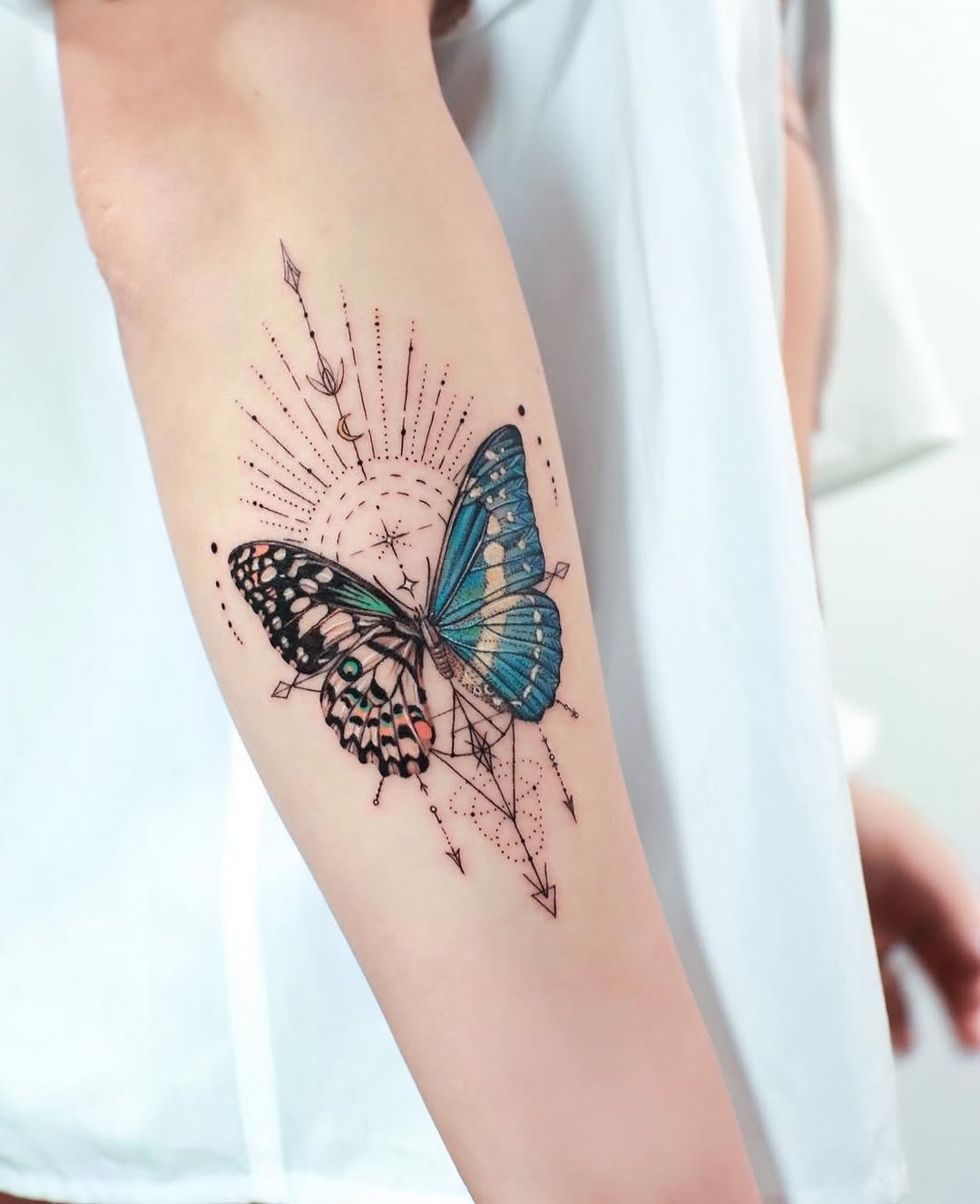 This butterfly tattoo captures the essence of nature's beauty with its rich blue and orange hues.
