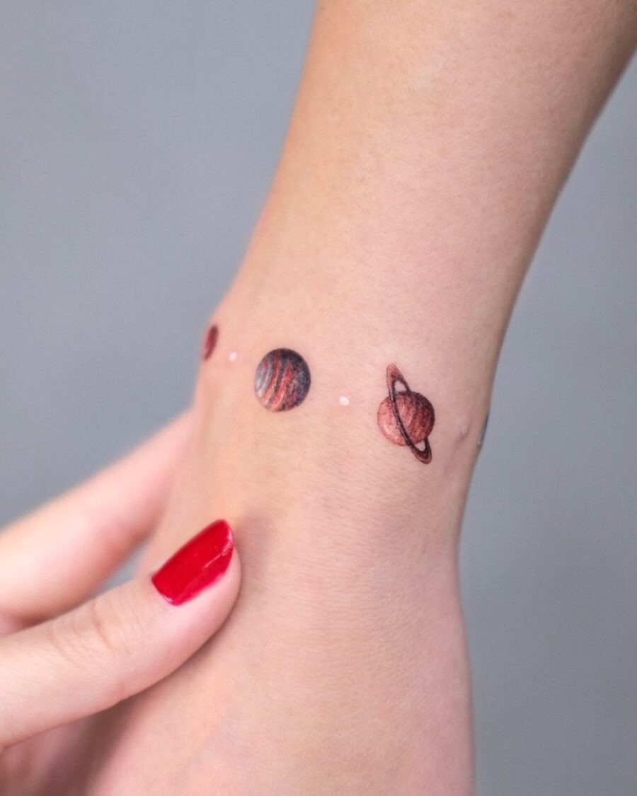 Charming Planets Tattoo on the Wrist Tattoo Design