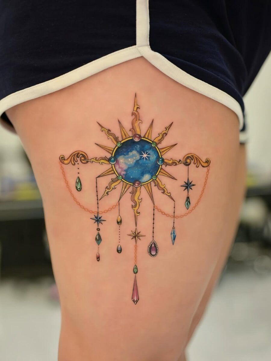 Glamorous celestial sun tattoo with hanging gems Tattoo Design
