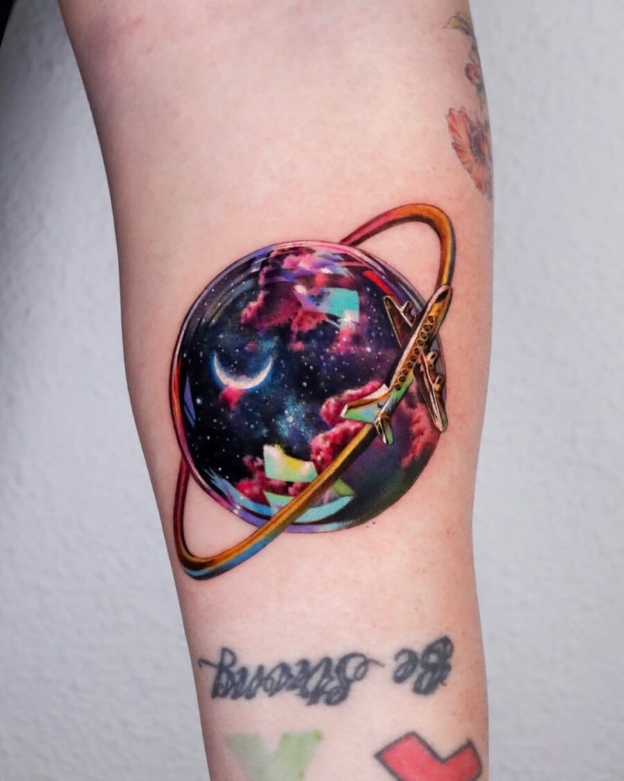 Vibrant Planetary Tattoo with a Spaceship Tattoo Design
