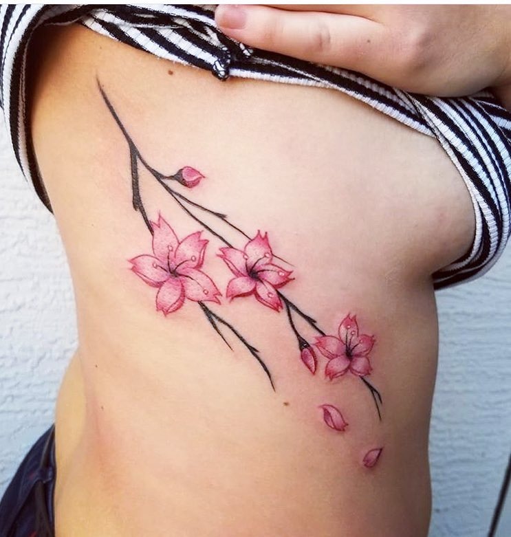 Cherry Blossom Rib Tattoo with Falling Petals Tattoo Design