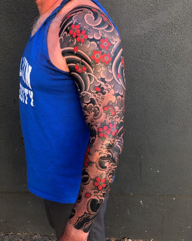 Traditional Wave and Cherry Blossom Sleeve Tattoo Tattoo Design