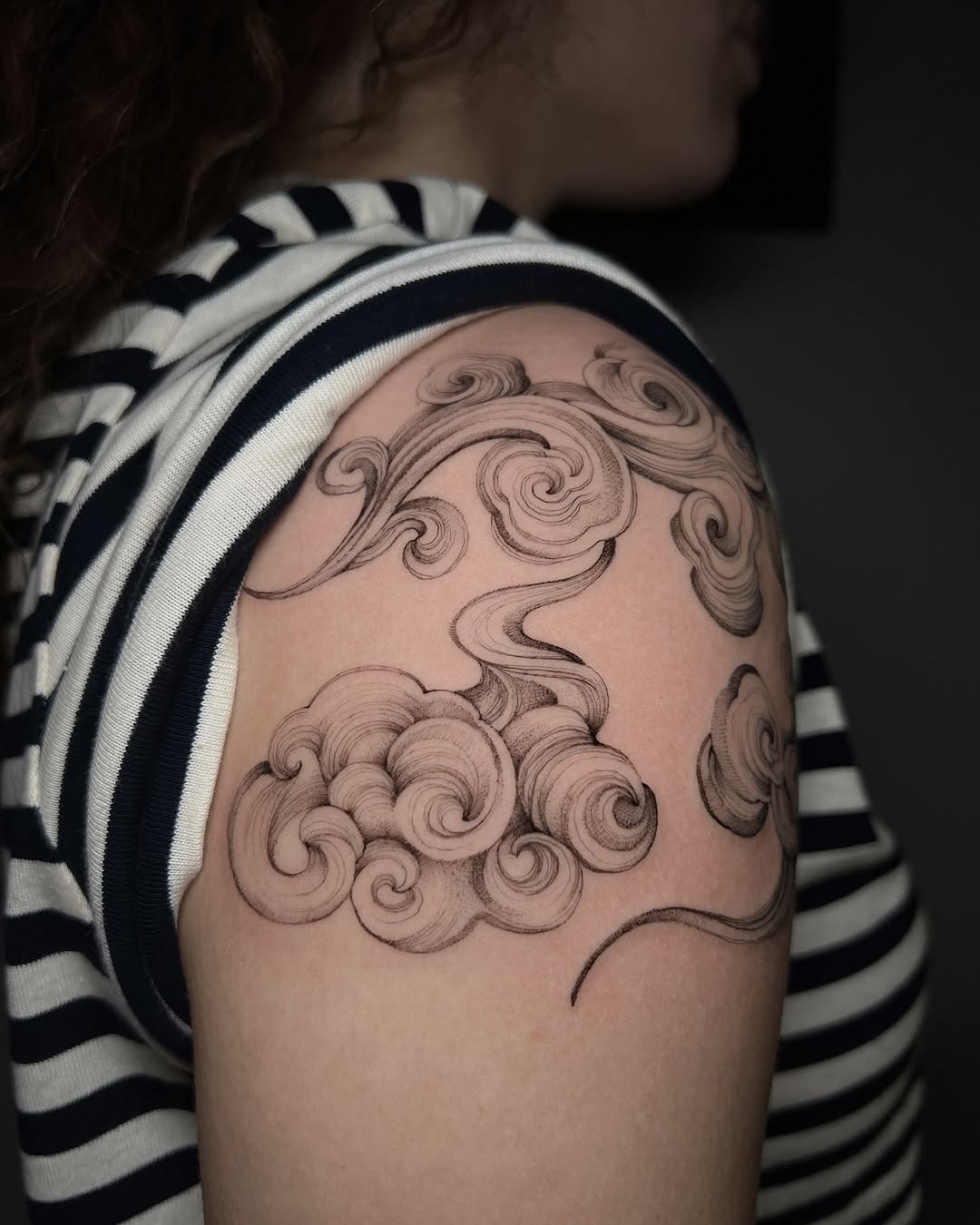 Artistic swirls of cloud tattoo on arm Tattoo Design