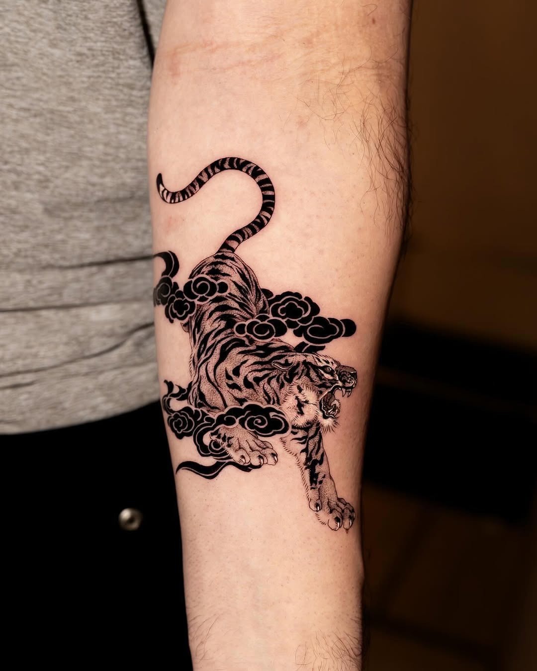 Dynamic tiger tattoo emerging from billowing clouds Tattoo Design