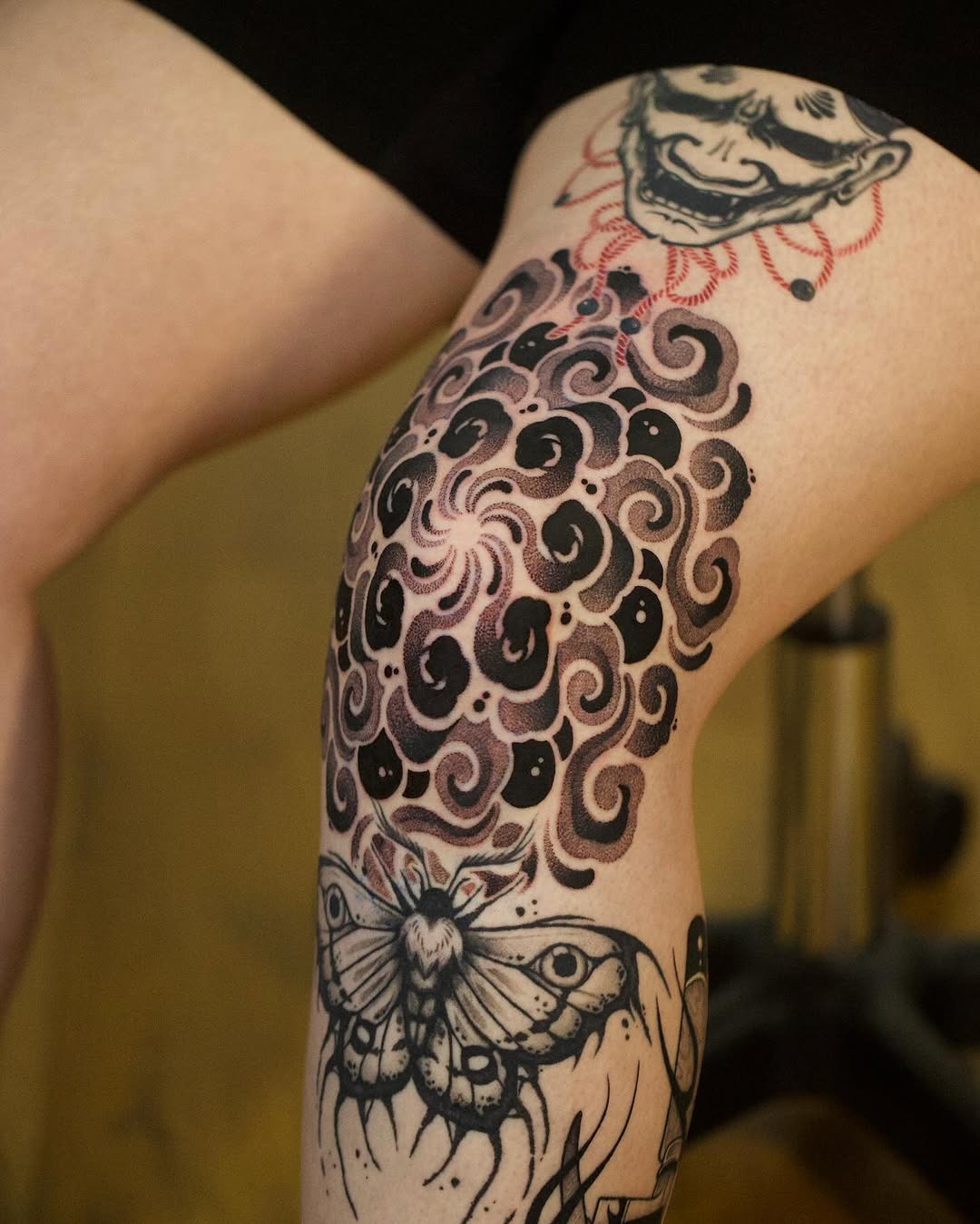 Flowing cloud and moth tattoo on leg Tattoo Design