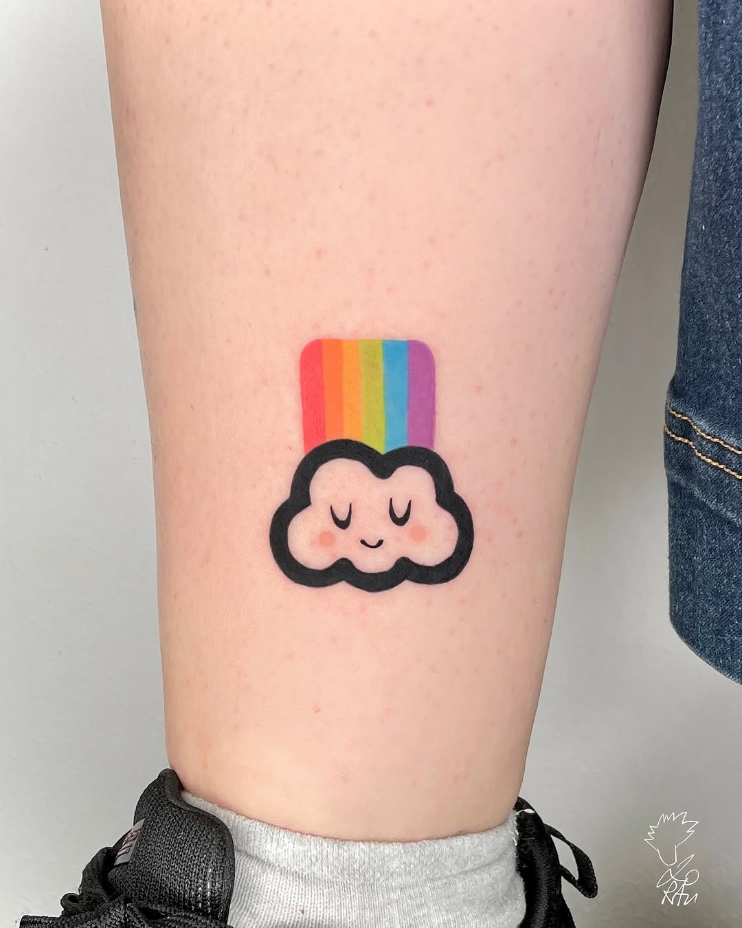 Playful cloud tattoo with rainbow elements Tattoo Design