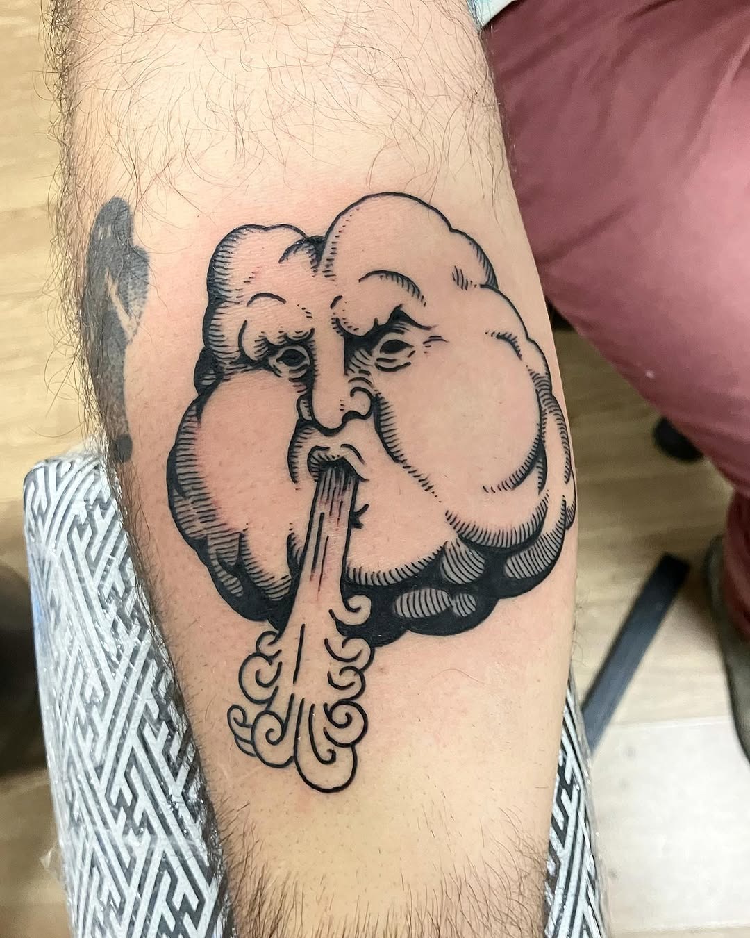 Unique cloud tattoo with a fierce expression Tattoo Design
