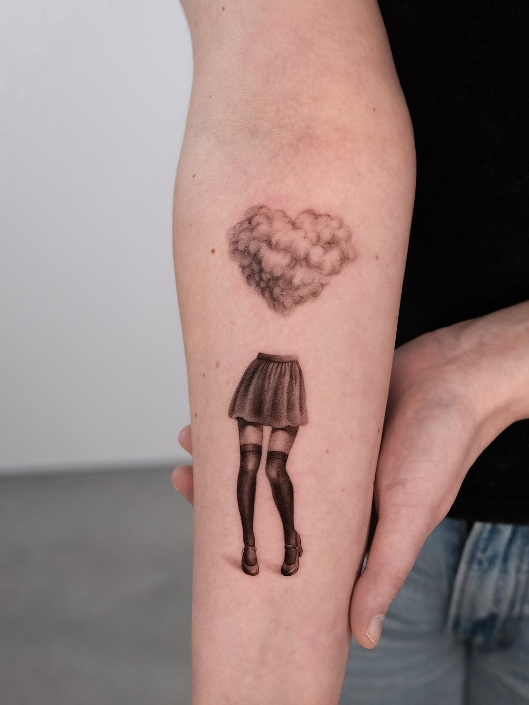 Whimsical cloud heart above stylish legs tattoo. Tattoo Design