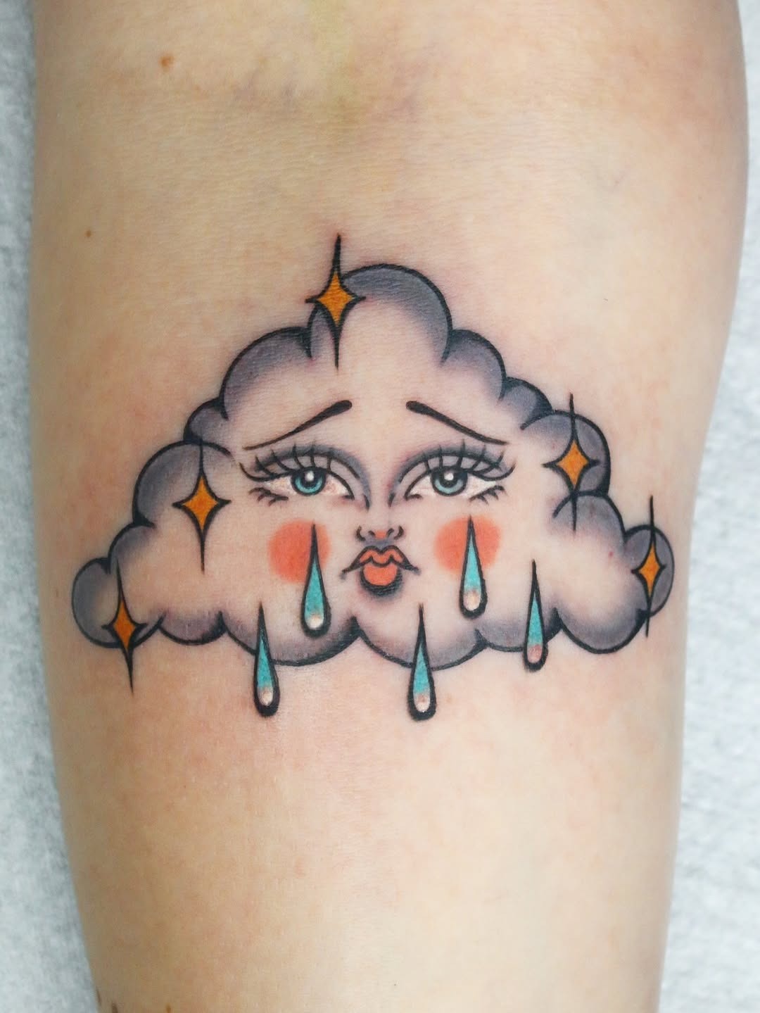 Whimsical cloud tattoo with a charming expression Tattoo Design