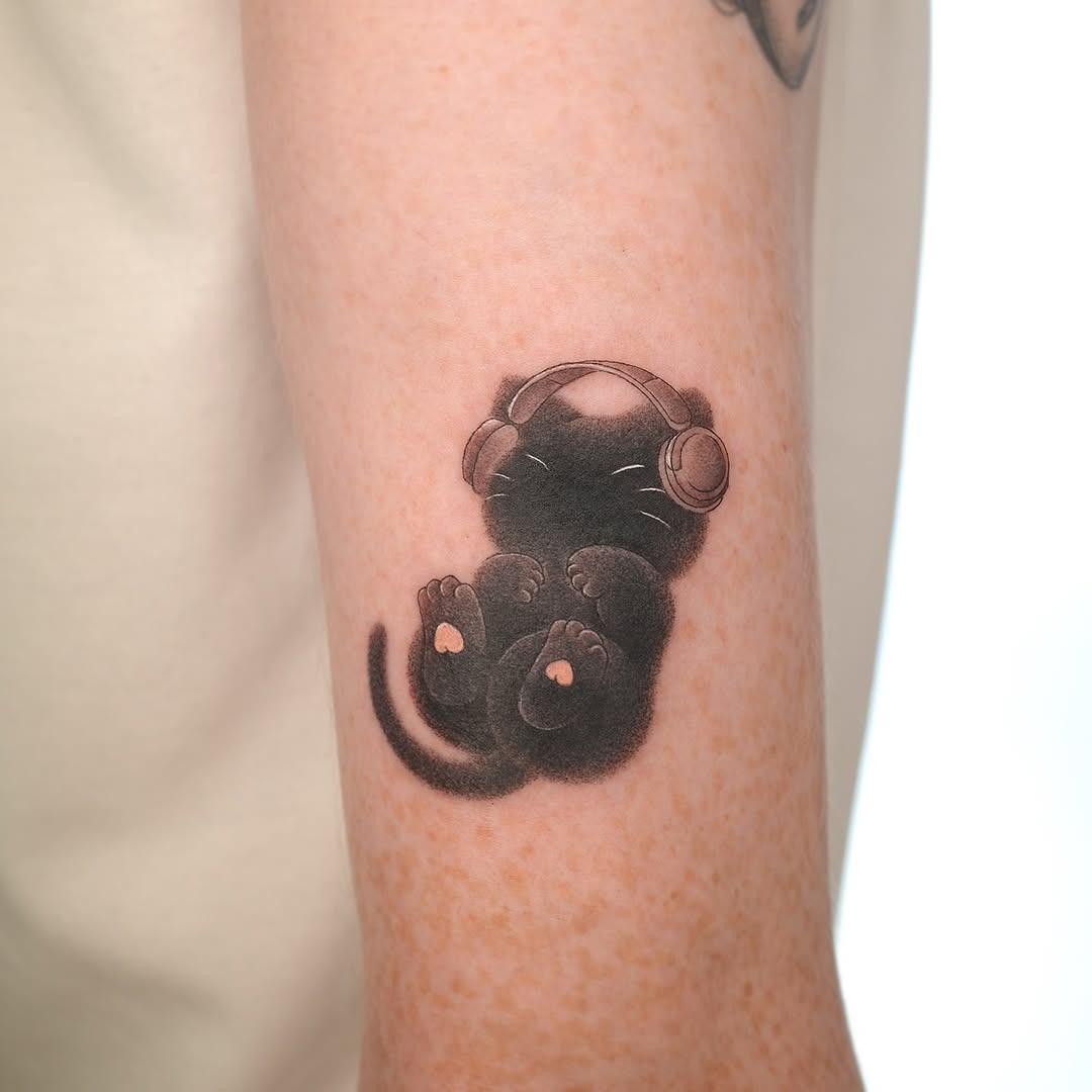 Adorable black cat tattoo wearing headphones Tattoo Design
