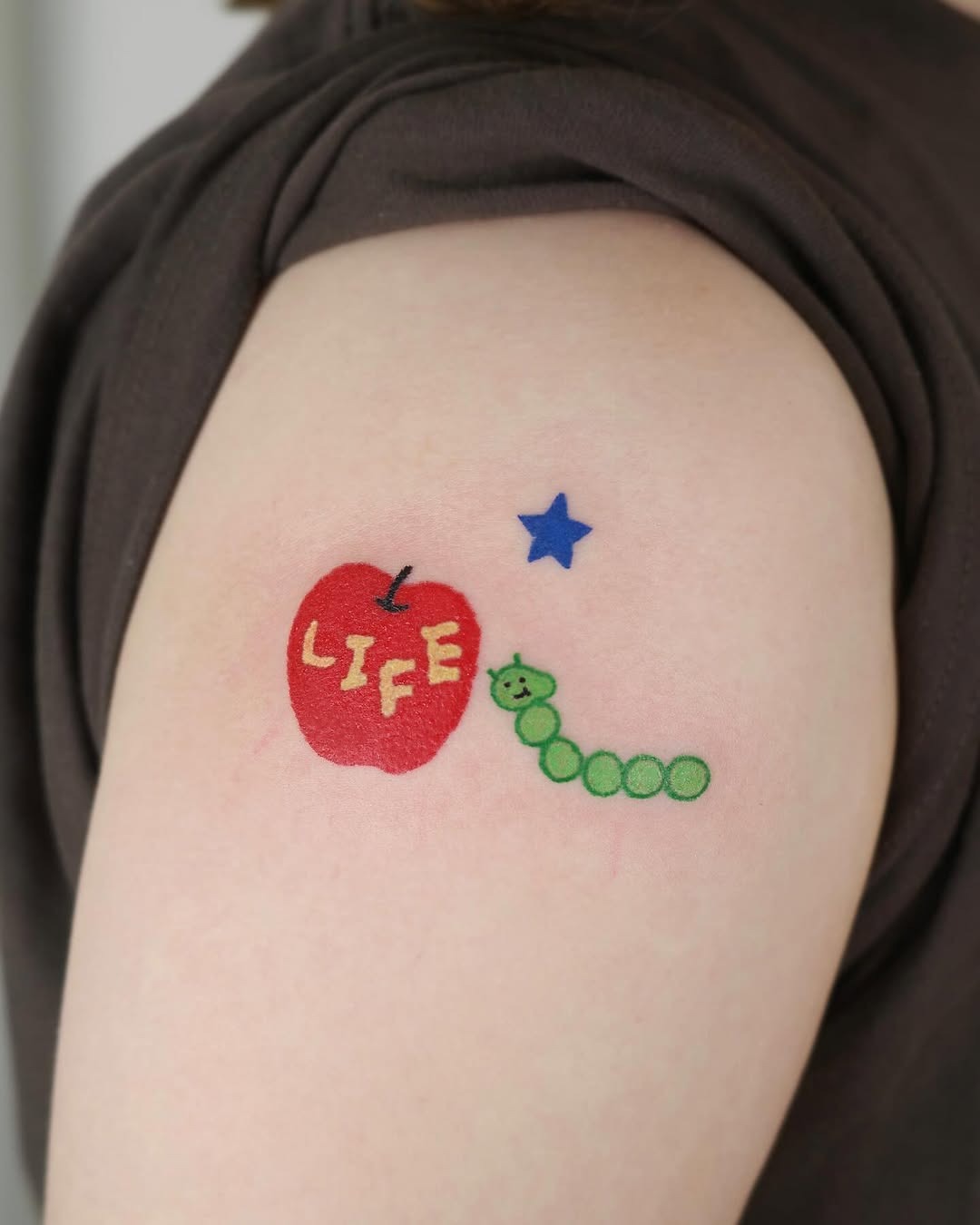 Playful apple and worm tattoo design Tattoo Design