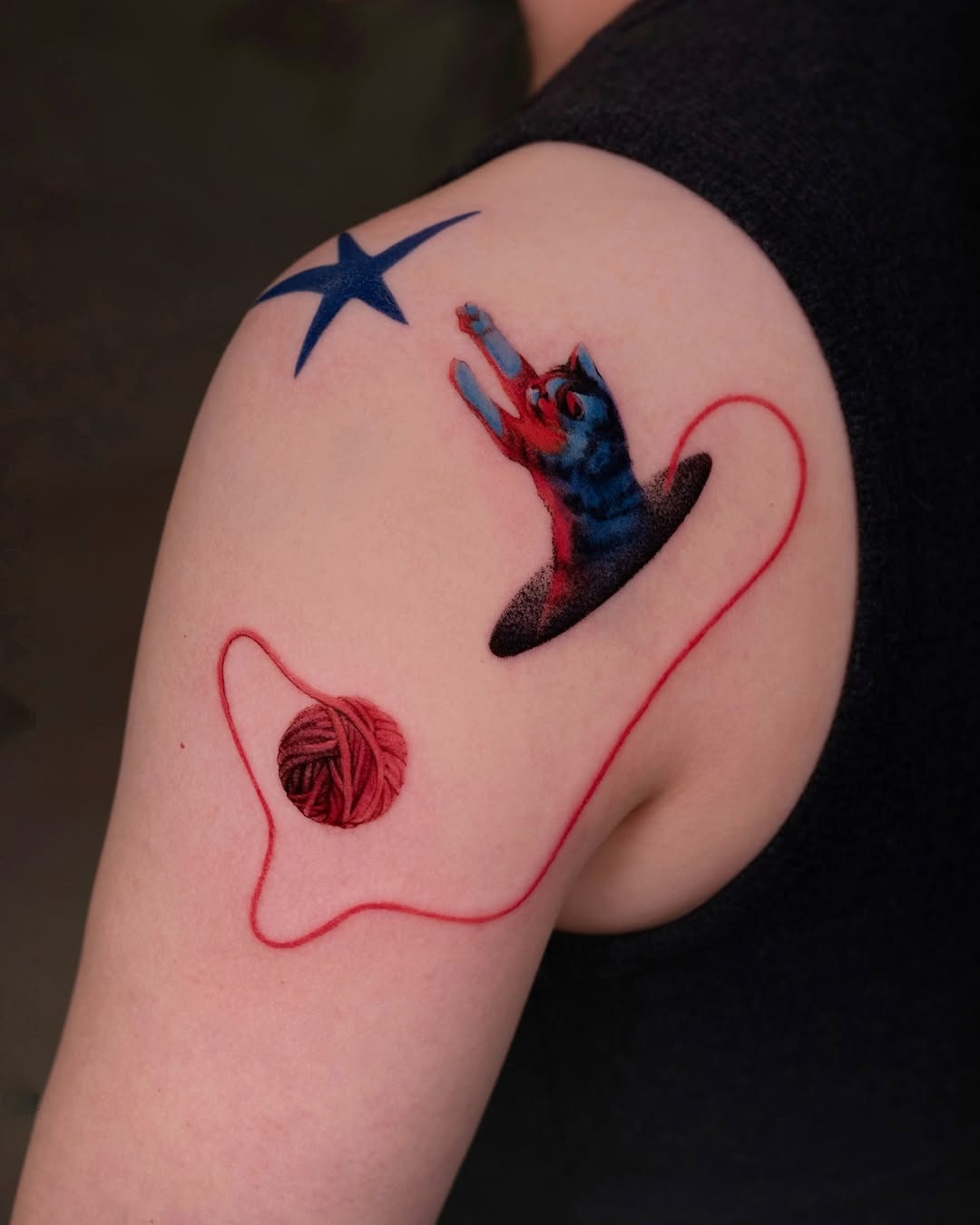 Playful cat tattoo with yarn and star Tattoo Design