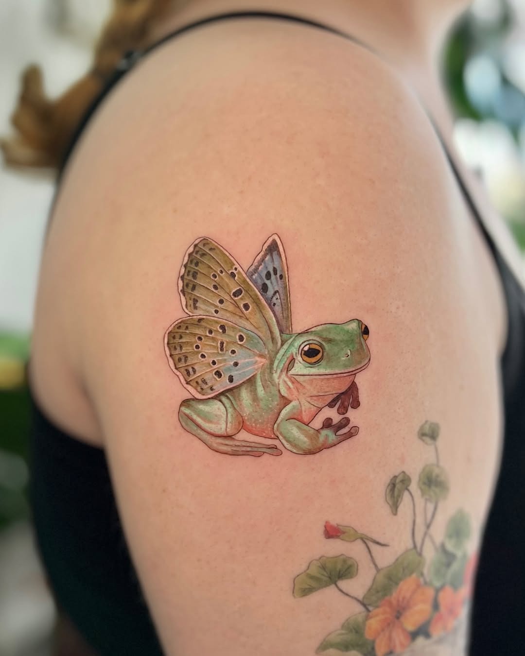Whimsical frog tattoo with colorful wings Tattoo Design