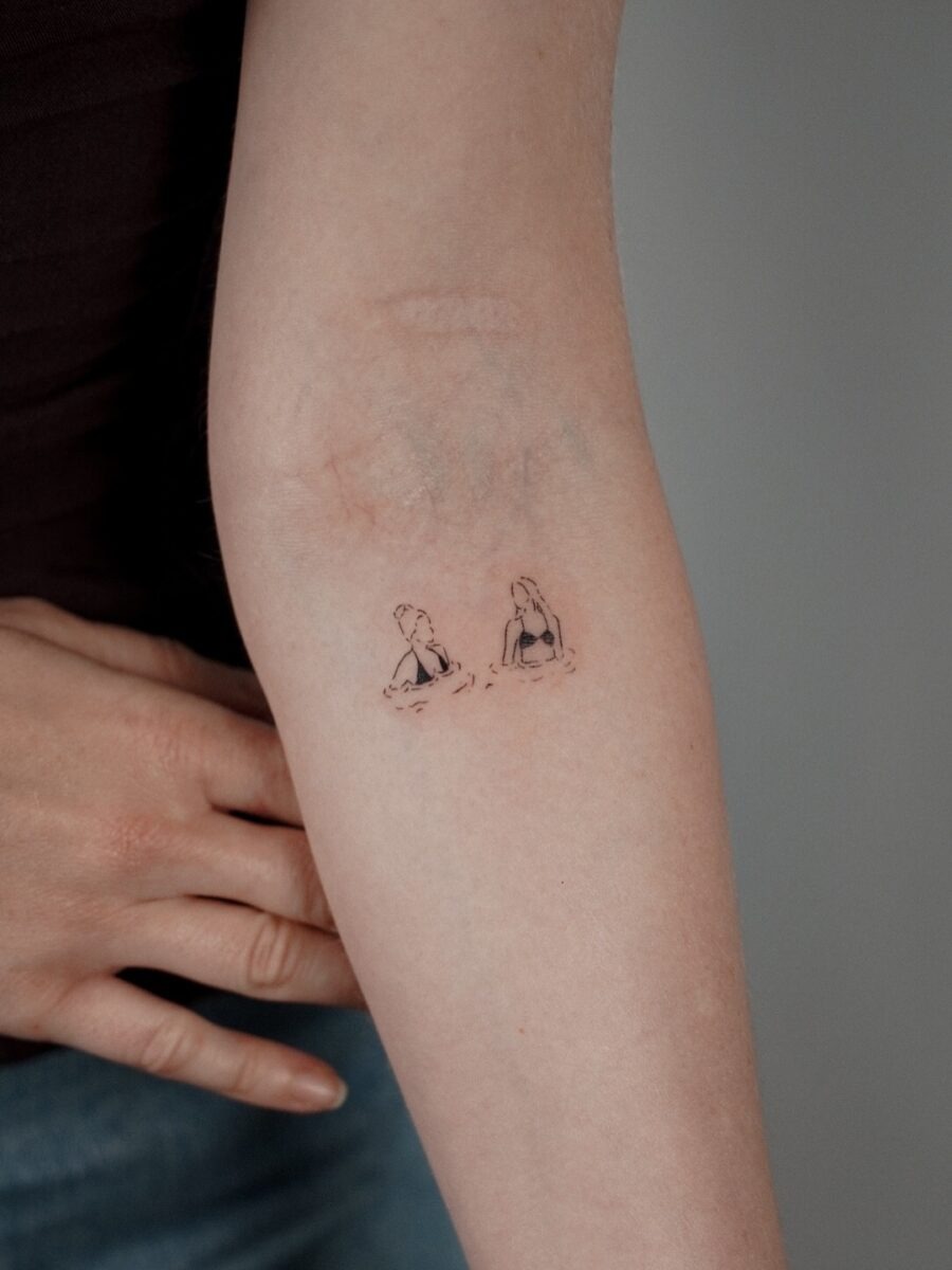 Charming Elbow Tattoo Featuring Two Girls Tattoo Design