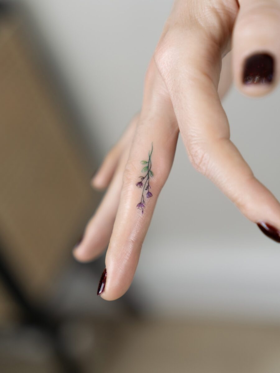 Delicate flower tattoo on fingertip Tattoo Design