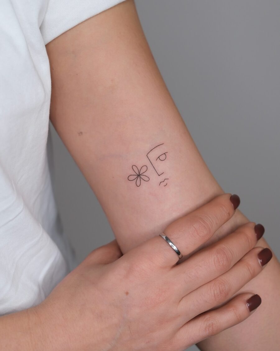Minimalist face tattoo with floral elements Tattoo Design