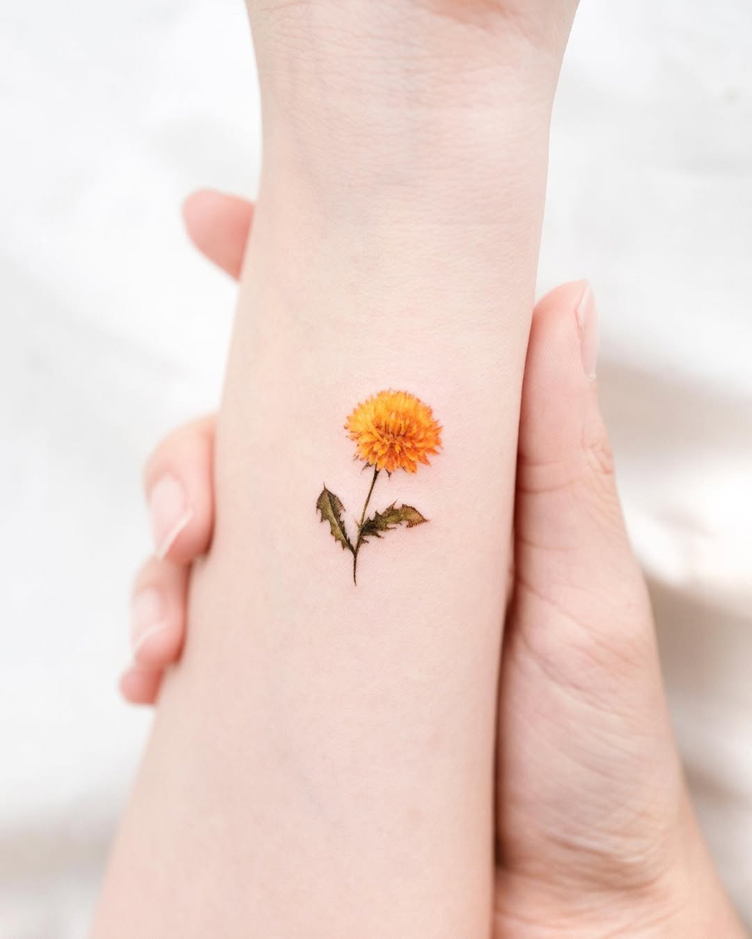 Bright orange dandelion tattoo with subtle details Tattoo Design