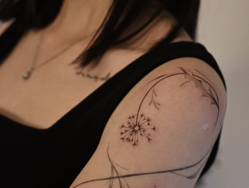 Delicate dandelion tattoo on the arm Tattoo Design