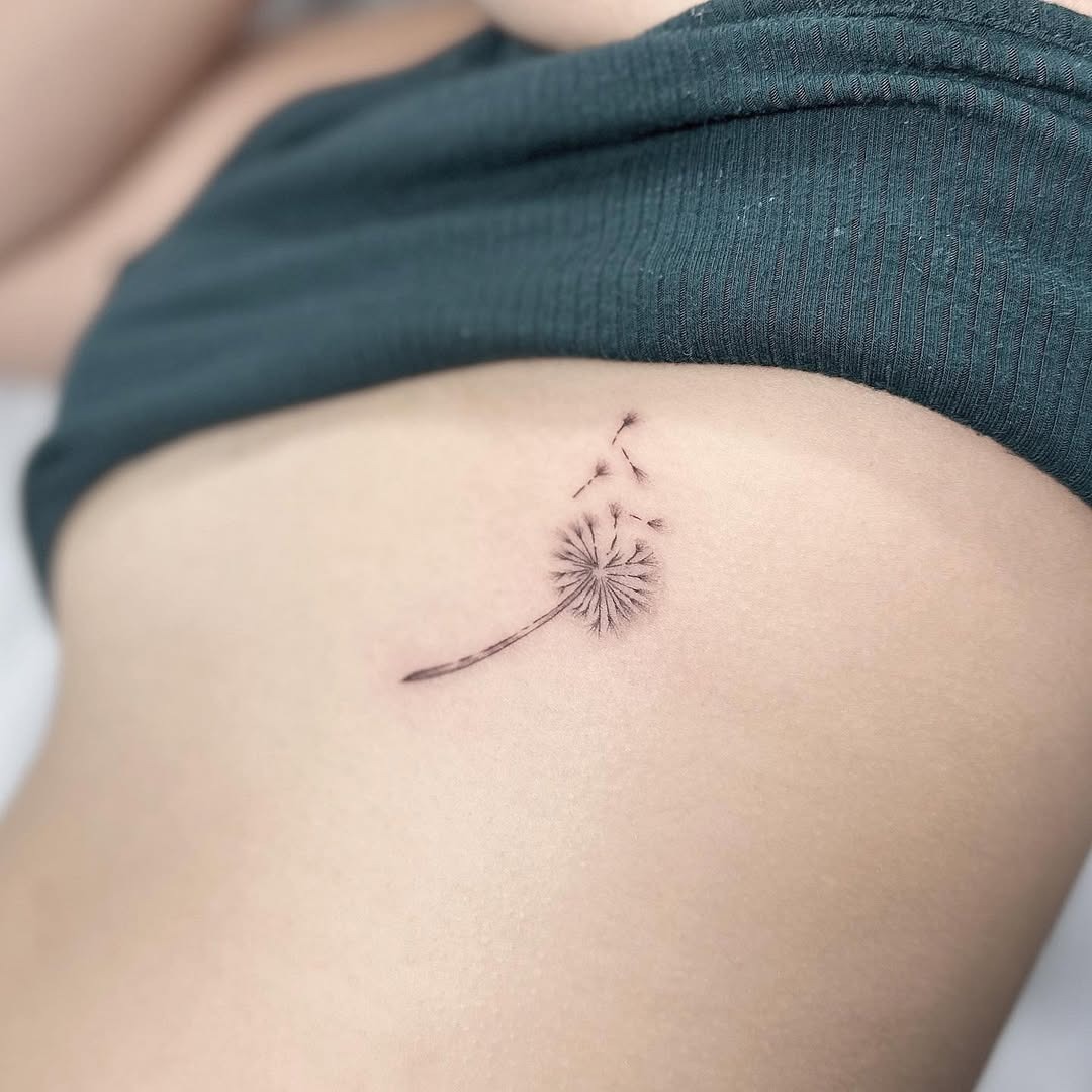 Delicate dandelion tattoo on the side Tattoo Design