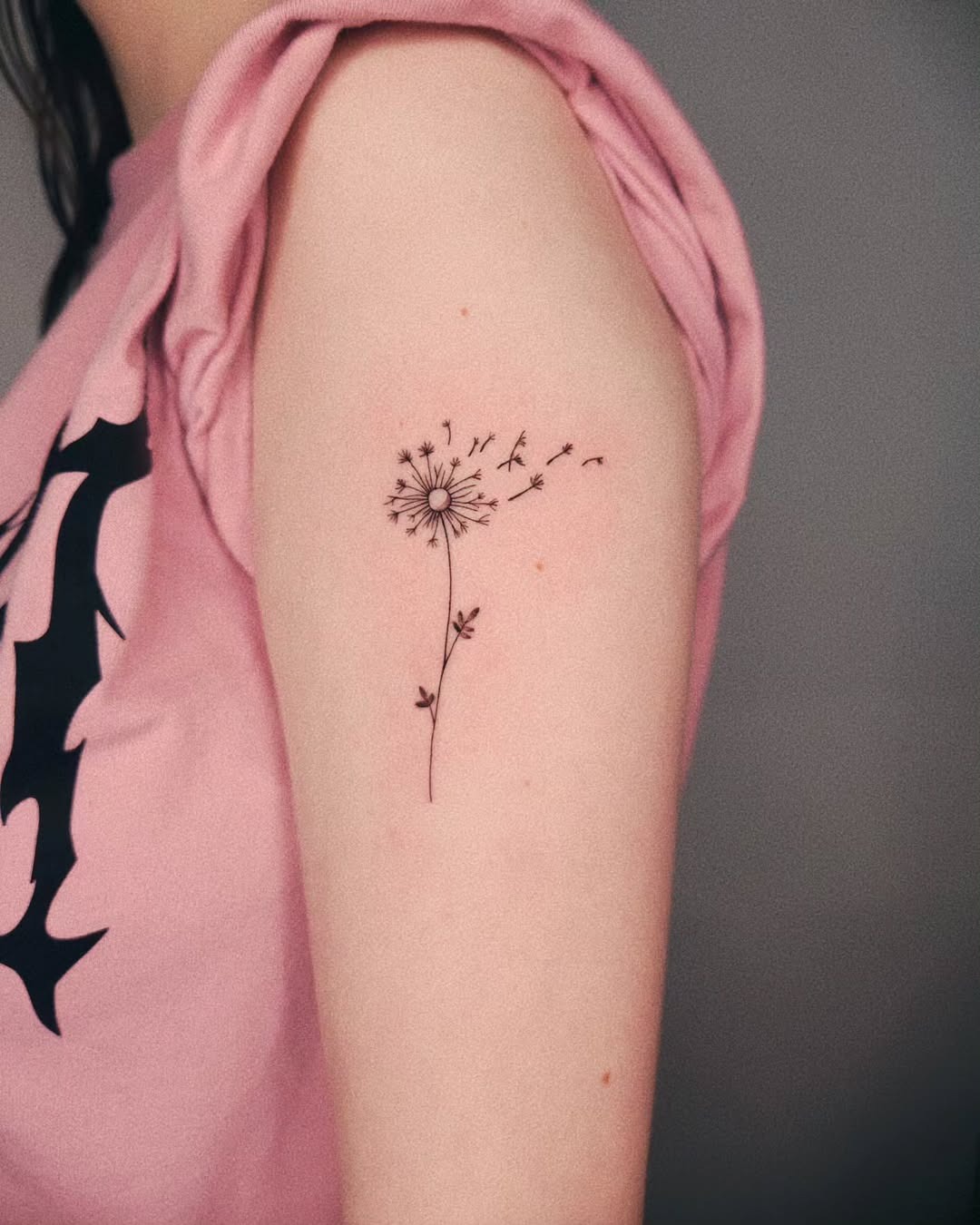 Delicate dandelion tattoo with flowing seeds Tattoo Design