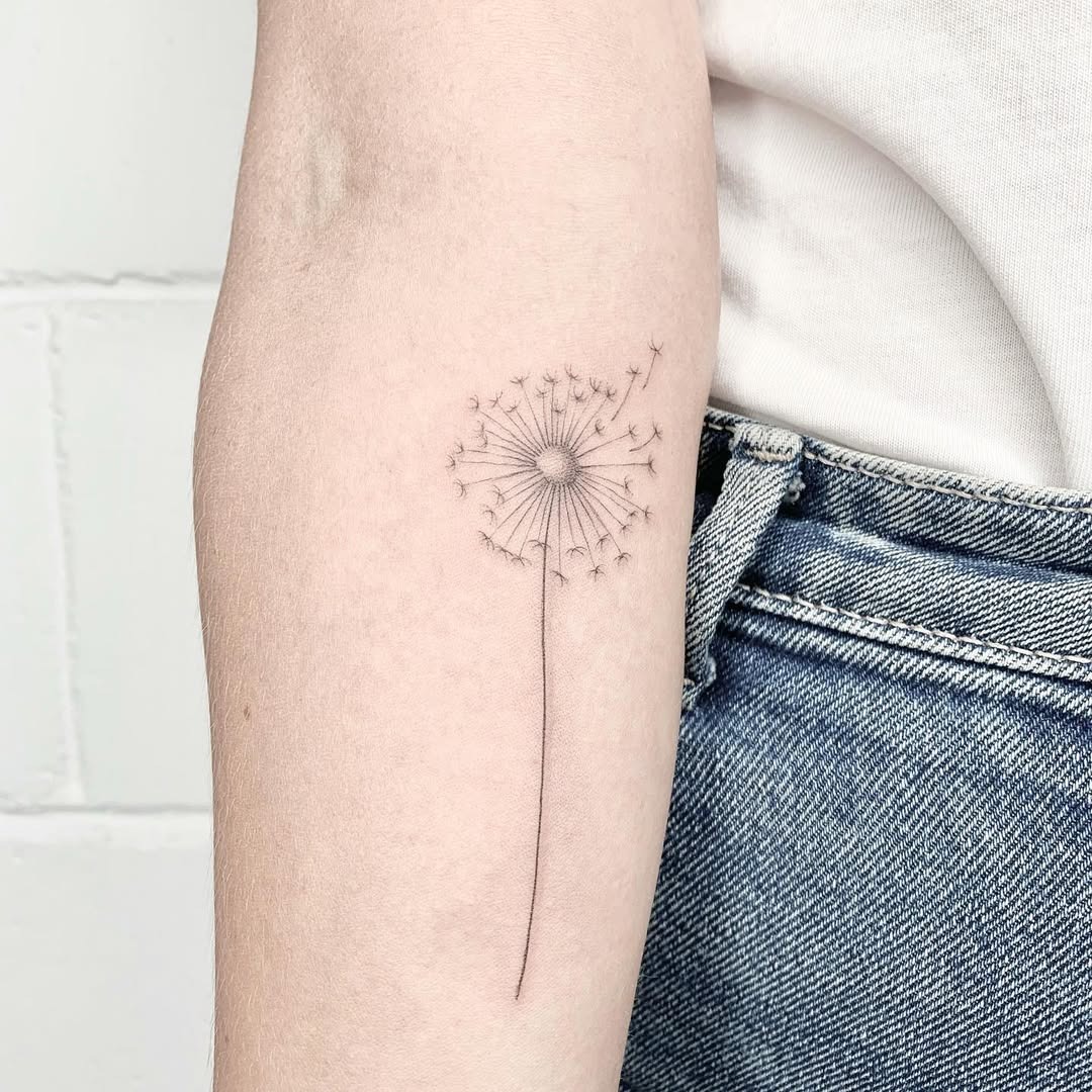 Elegant dandelion tattoo with delicate detail Tattoo Design