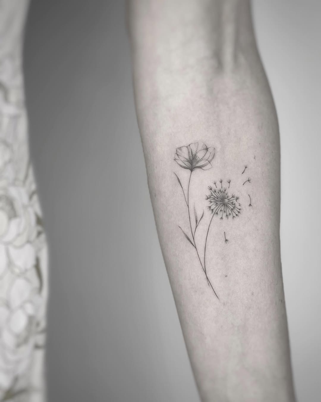 Elegant dandelion tattoo with delicate flower details Tattoo Design