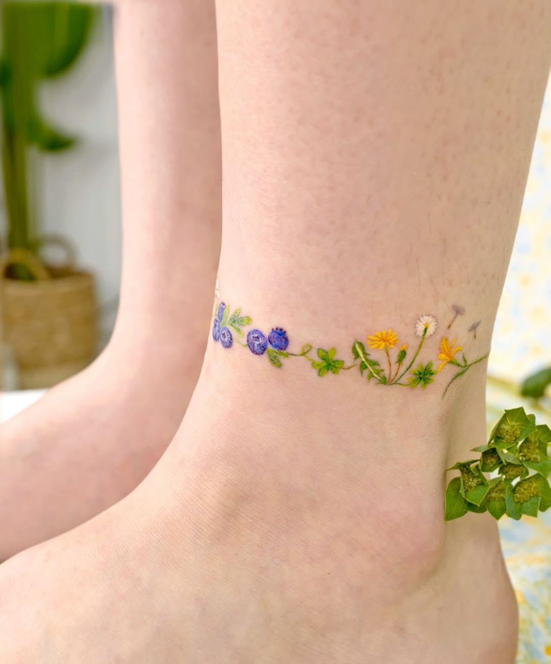 Whimsical ankle tattoo featuring colorful wildflowers Tattoo Design