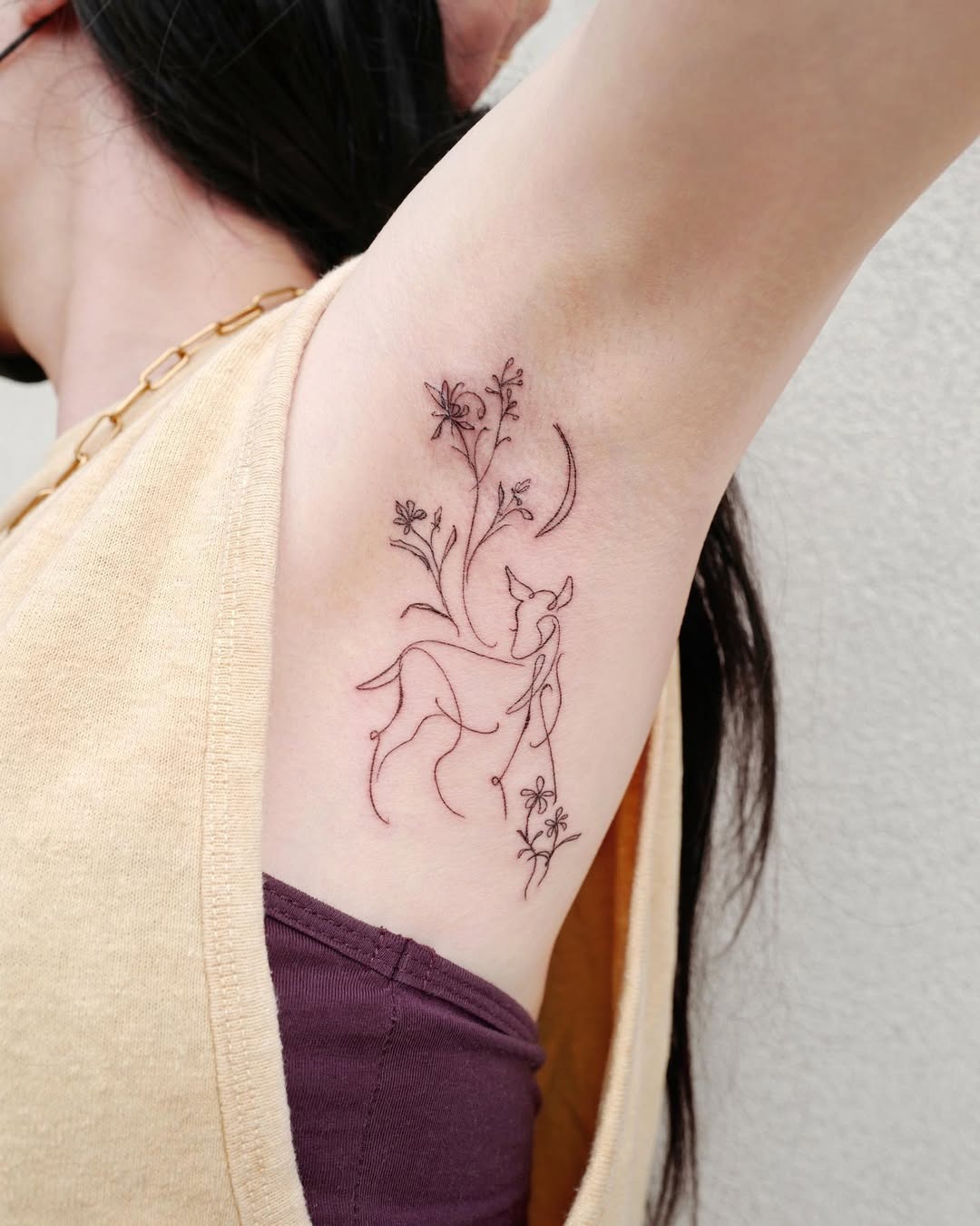 Delicate deer tattoo with floral elements Tattoo Design