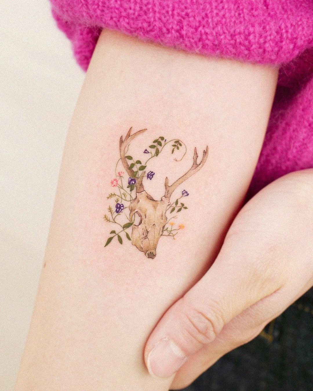 Elegant deer skull tattoo with floral accents Tattoo Design